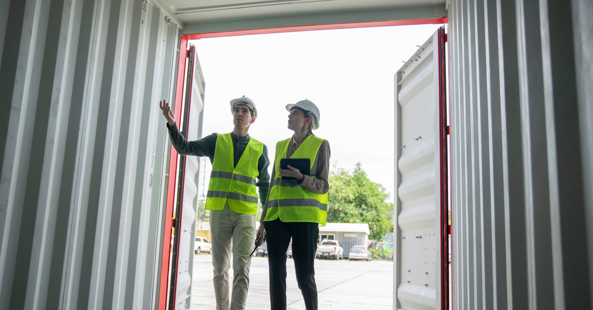 Foreman are discussing for stack container at cargo site logistics service transportation.