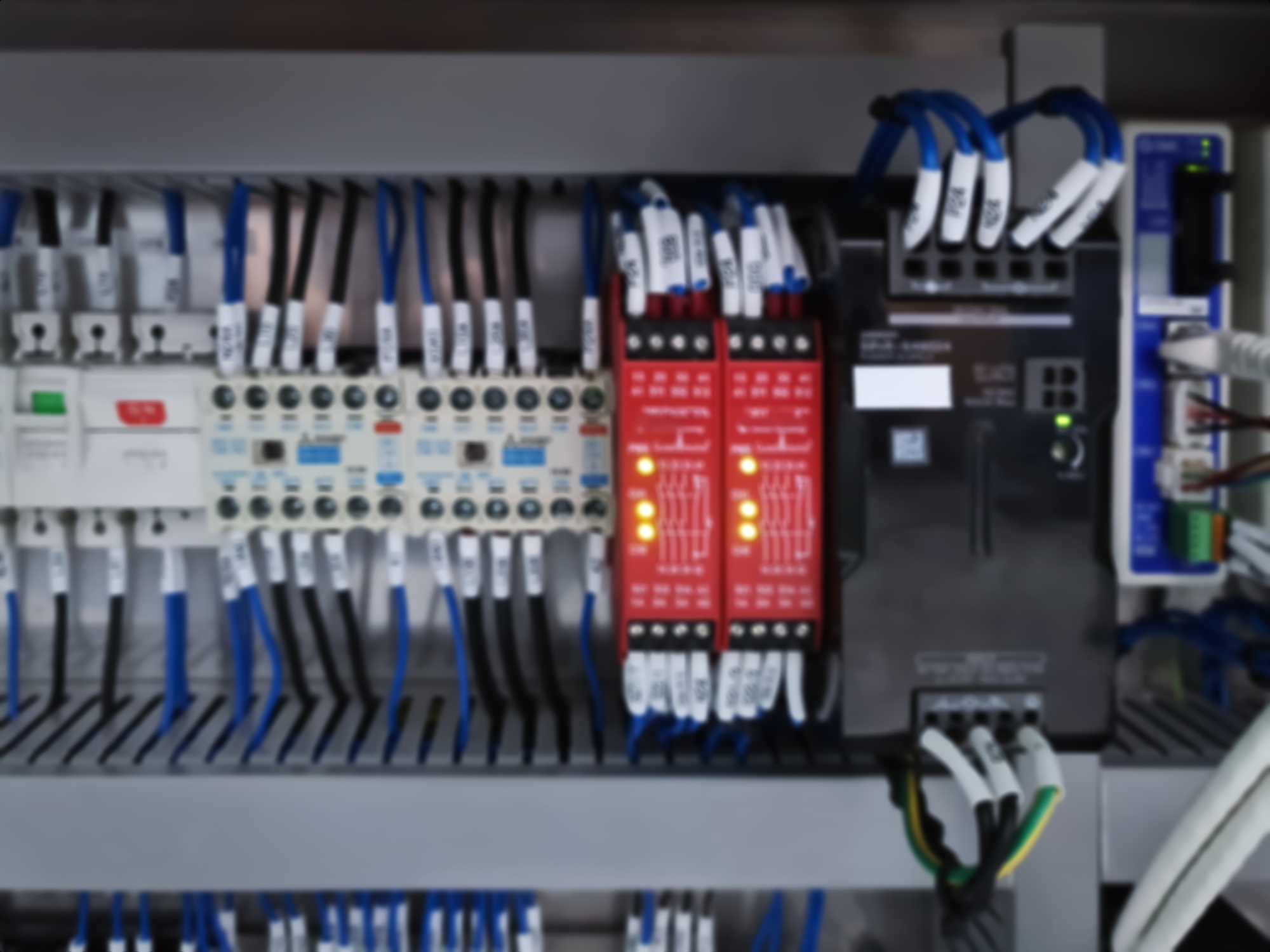 Blurred Background of Switches and Wiring Inside of Electrical Control Cabinet